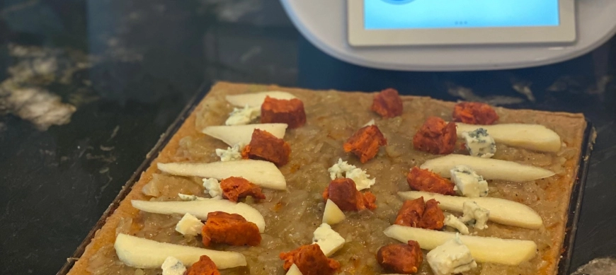 COCA DE CEBOLLA CARAMELIZADA , PERA , ROQUEFORT Y SOBRASADA .